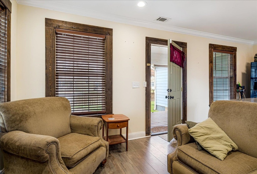 Sitting room featuring hardwood / wood-style flooring, ornamental molding, and recessed lighting