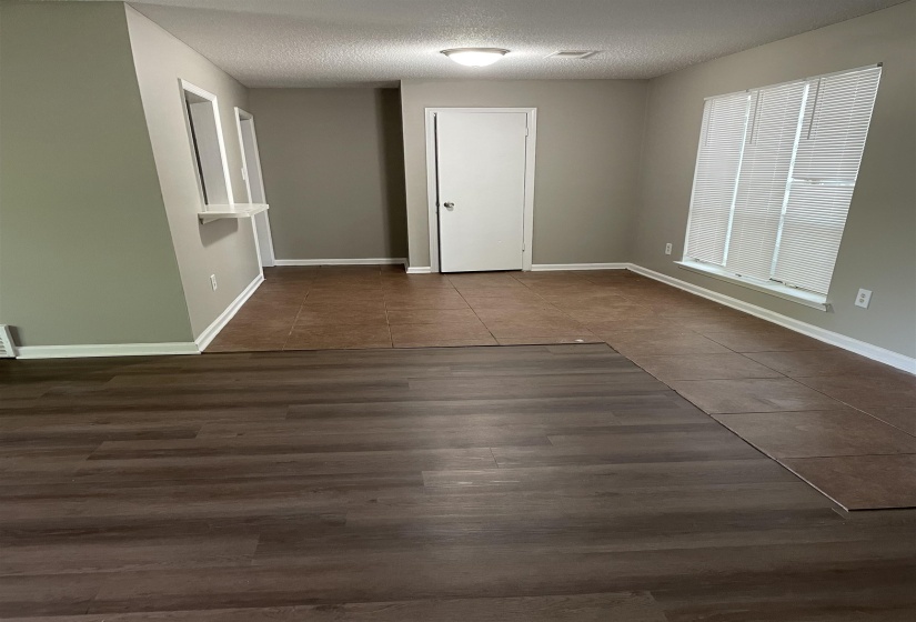 Unfurnished room with a textured ceiling and dark tile patterned floors