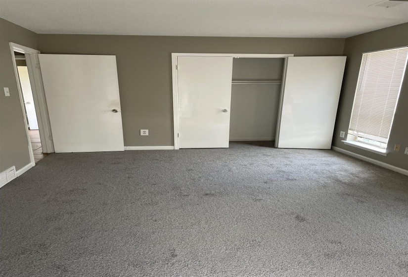 Unfurnished bedroom featuring carpet and a closet