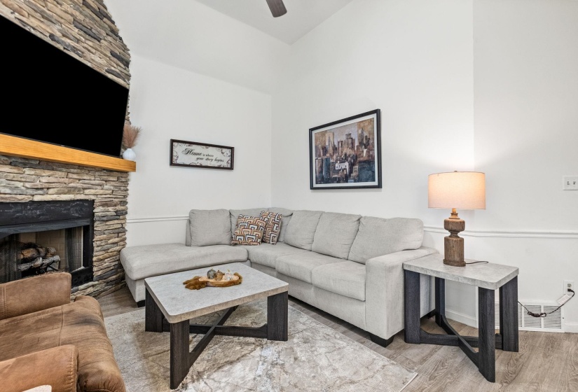 Stone-clad fireplace with a wood mantel