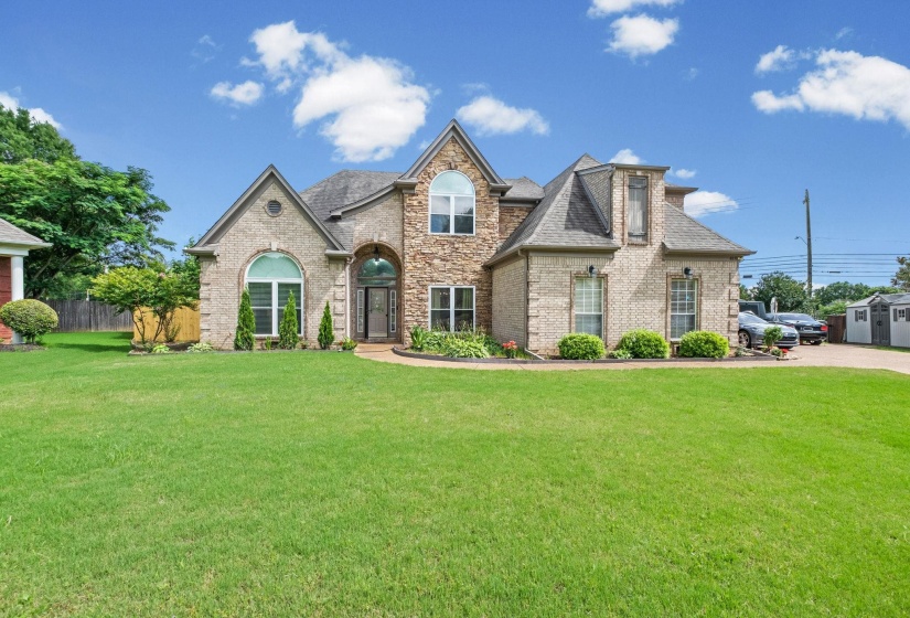 Stately brick and stone exterior with arched windows