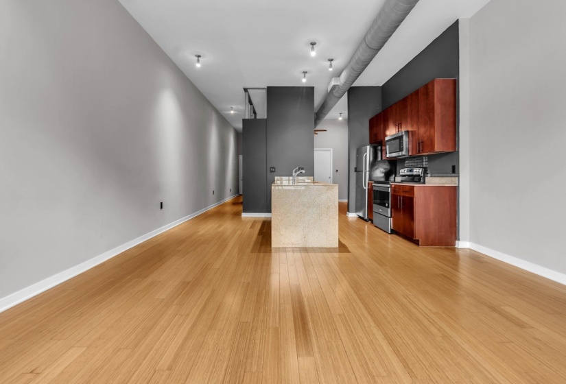 Open-concept living space with wood-finish flooring