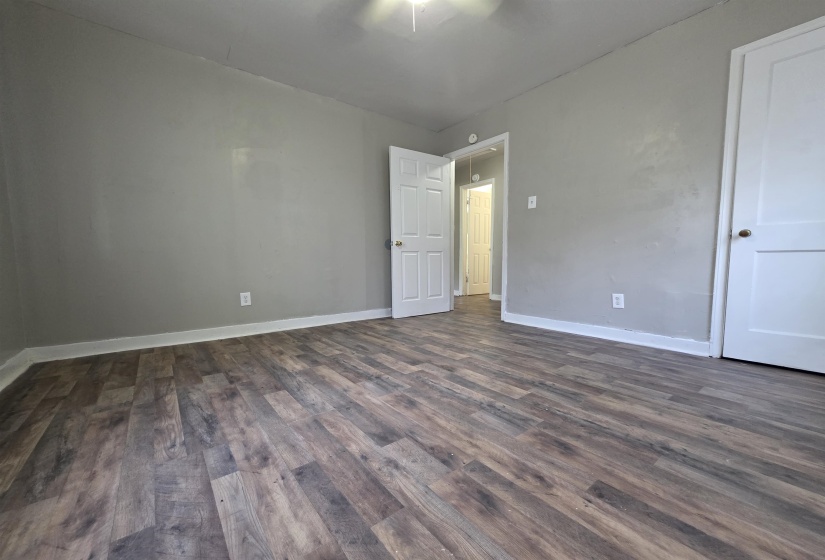 Wood-finish flooring throughout, complemented by light gray walls and white trim