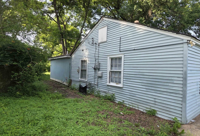 Light blue siding exterior featuring multiple windows and a gabled roofline
