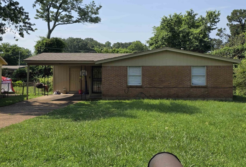 Brick exterior with a covered carport