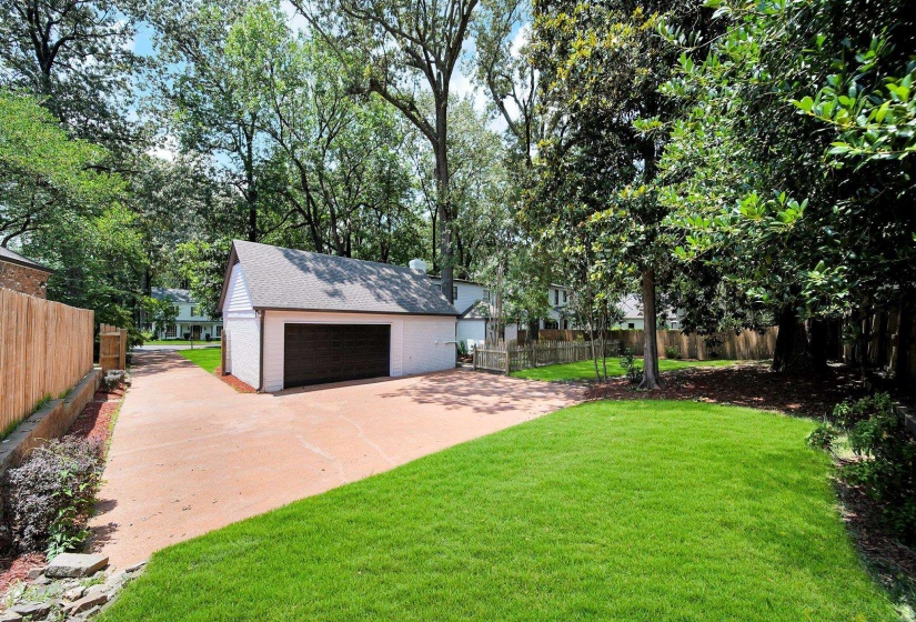 View of yard featuring a detached garage and an outdoor structure