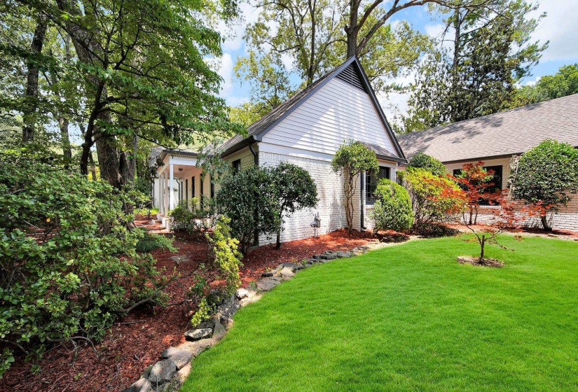 View of home's exterior with brick siding and a yard