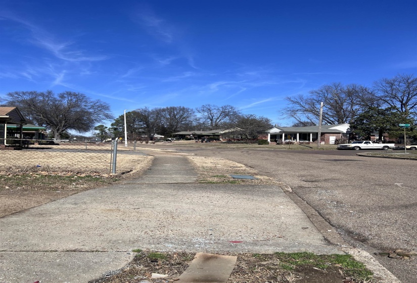 View of asphalt street featuring sidewalks