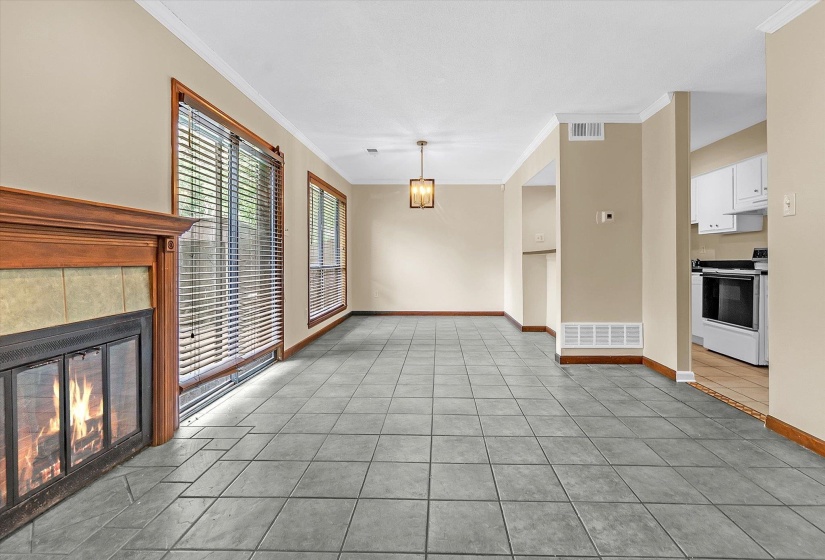 Living room and dining room features fresh paint, tile flooring, fireplace, and a breakfast bar.