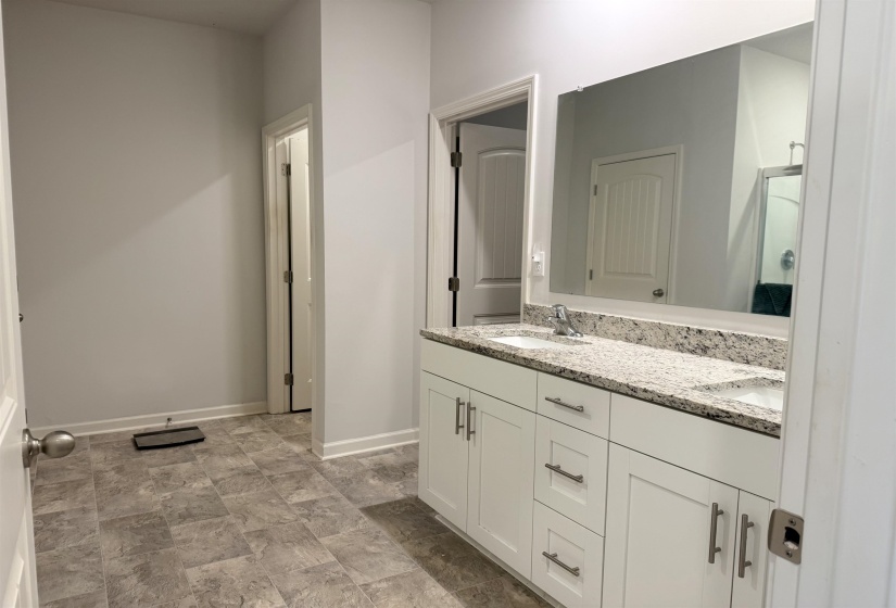 Dual vanity with light-toned countertop and integrated sinks