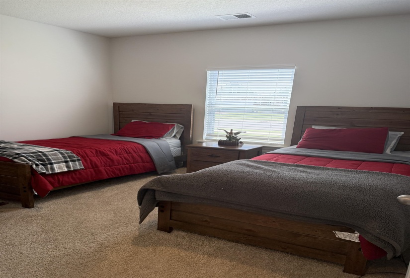 Room featuring neutral-toned carpet, a window with horizontal blinds, and recessed lighting