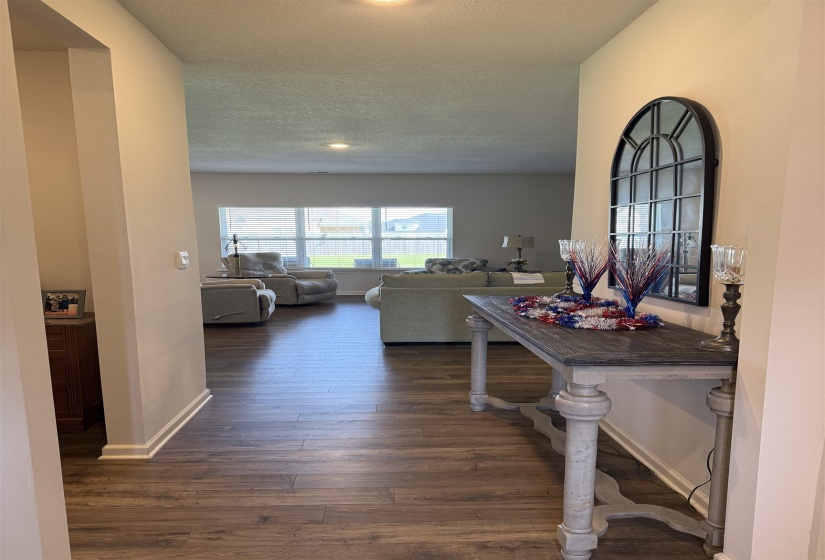 Hallway entry featuring wood-finish flooring extending into the main living space