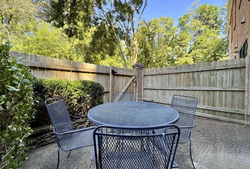 Fenced backyard featuring outdoor dining space and a patio