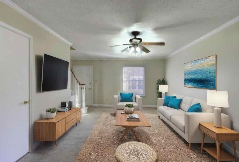 Carpeted living room with crown molding, a textured ceiling, ceiling fan, and stairway
