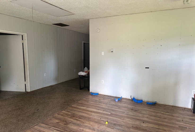 Unfurnished room featuring wood-type flooring and a textured ceiling