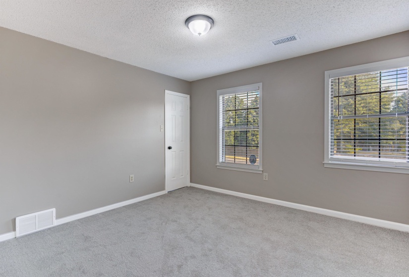 Spare room featuring carpet floors and a textured ceiling