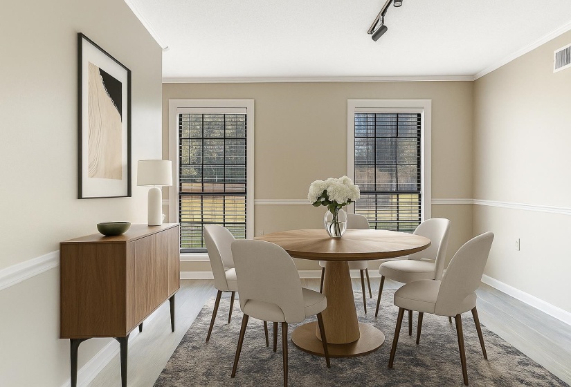 Dining room with light wood-type flooring, ornamental molding, and rail lighting