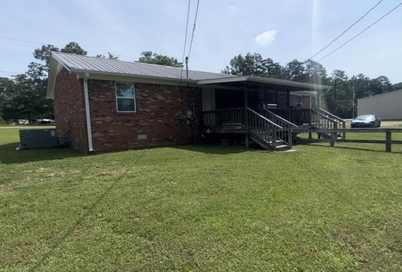 Brick exterior with a metal roof and white gutters