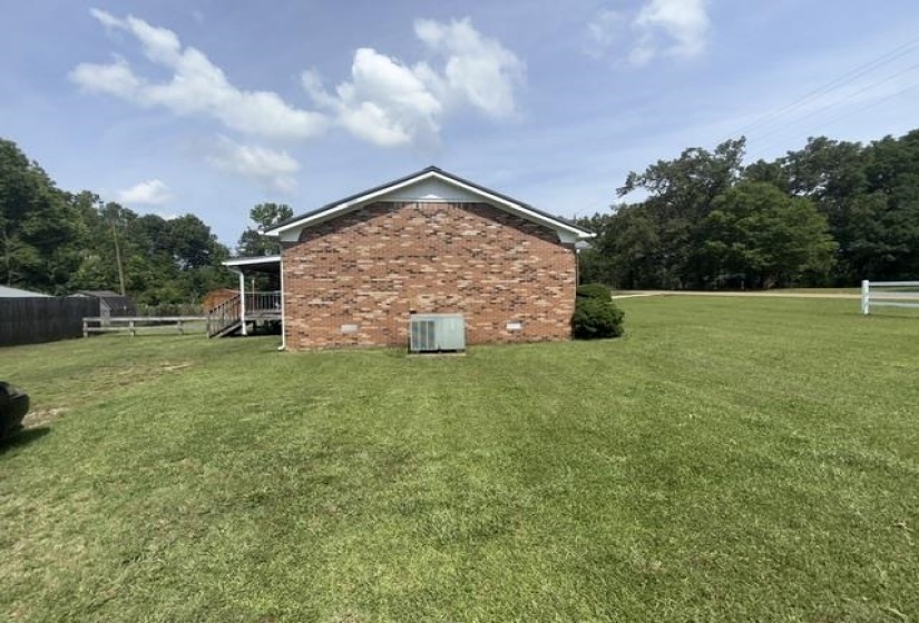 Red brick exterior featuring a white trim roofline
