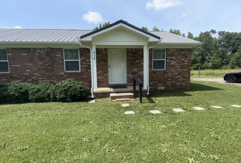 Brick exterior with a covered porch entry