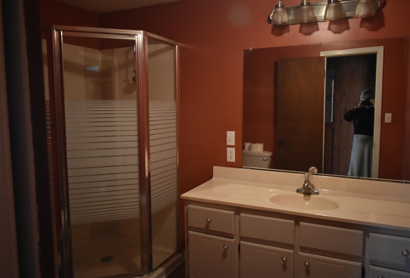 Full bath featuring a shower stall and vanity