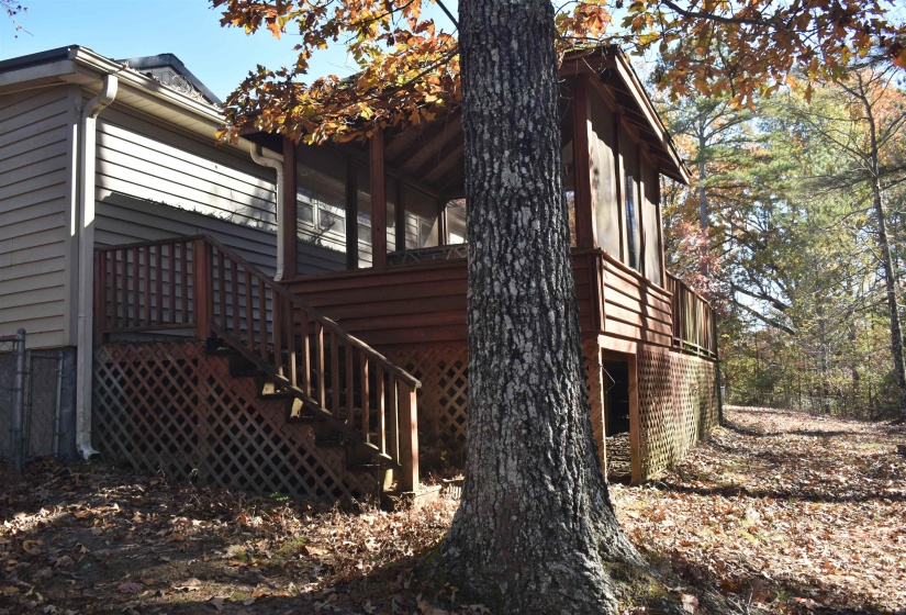 View of property exterior with a deck and stairs