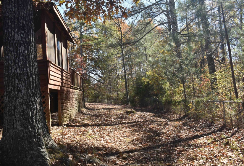 View of home's exterior with a wooded view