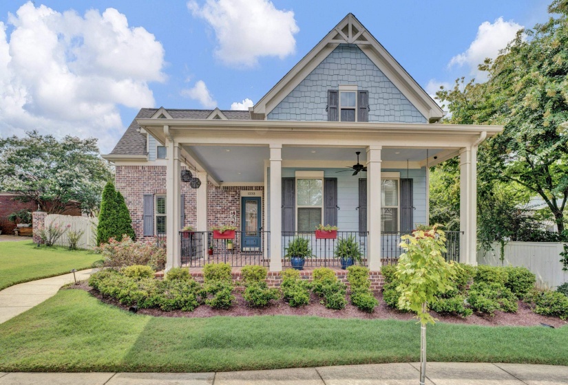 Traditional brick and siding exterior with a covered front porch featuring four columns