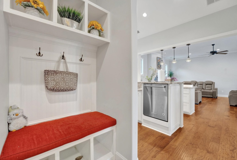 Built-in mudroom bench with cubby storage and upper shelving