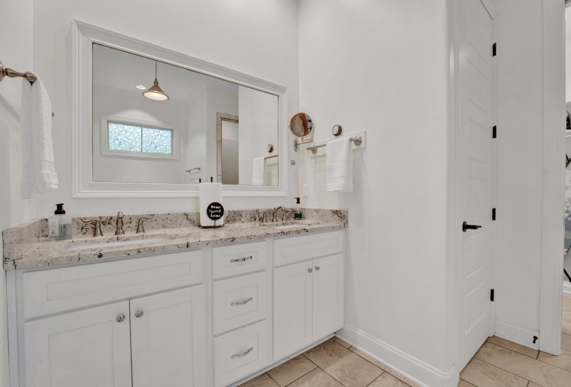 White double vanity with a speckled countertop and dual undermount sinks