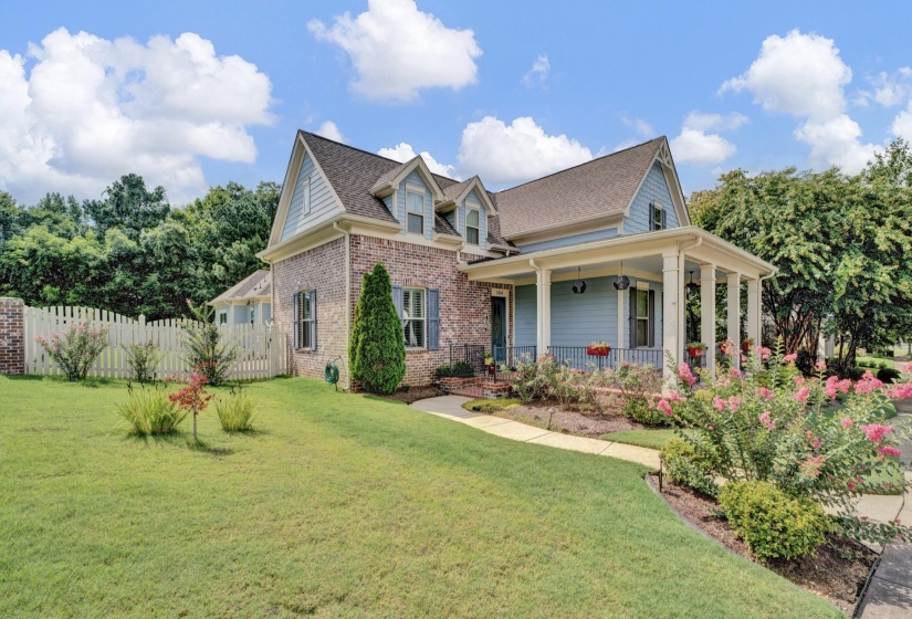 Traditional-style residence featuring a brick and siding exterior, multi-gabled roofline, and dormer windows