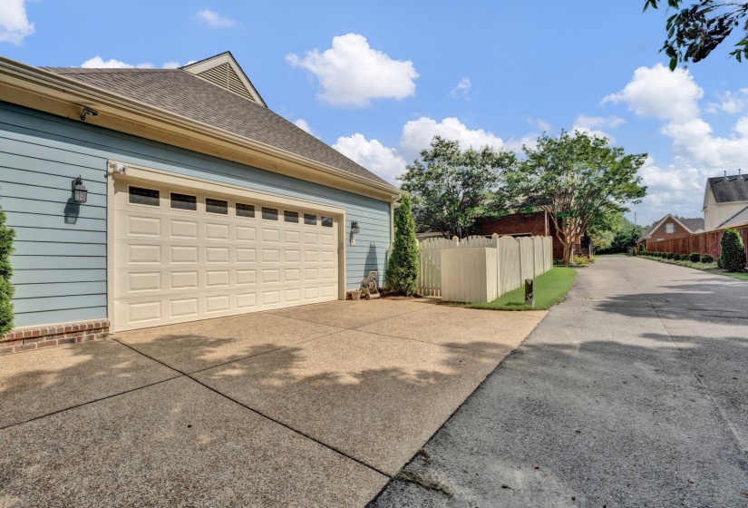Two-car garage with a panel-style door and upper window inserts