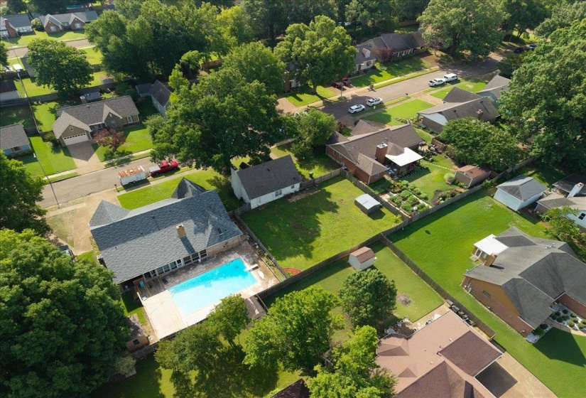 Aerial perspective showcasing a residential property with a private swimming pool