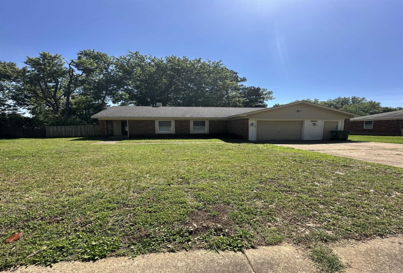 Single story home featuring a garage and concrete driveway