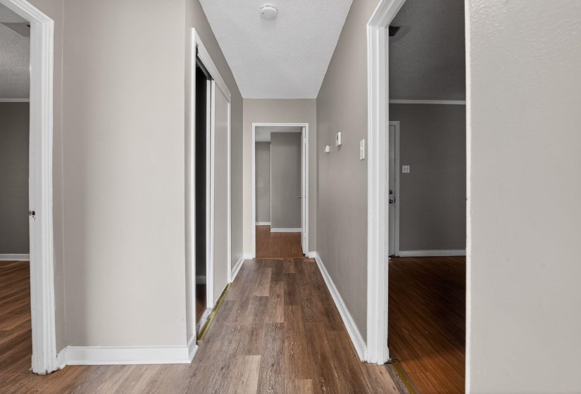Corridor featuring wood finished floors and a textured ceiling