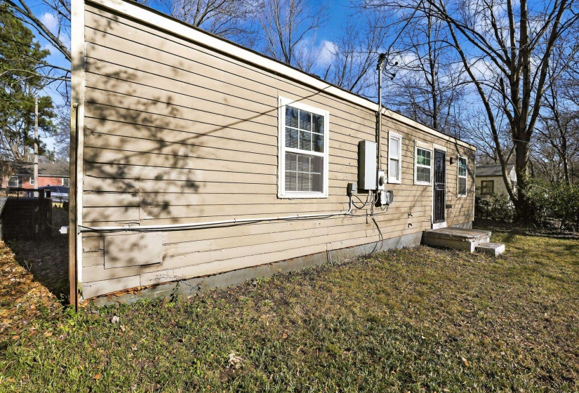 View of side of home featuring a lawn