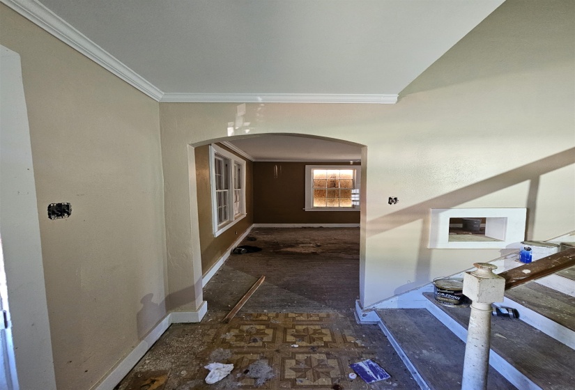 Arched entryway leading to an interior space with multiple windows
