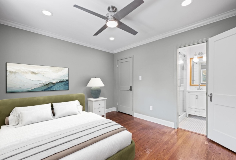 Hardwood flooring paired with crown molding and recessed lighting