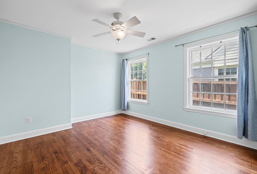 Hardwood flooring underfoot, complemented by light blue walls and white trim