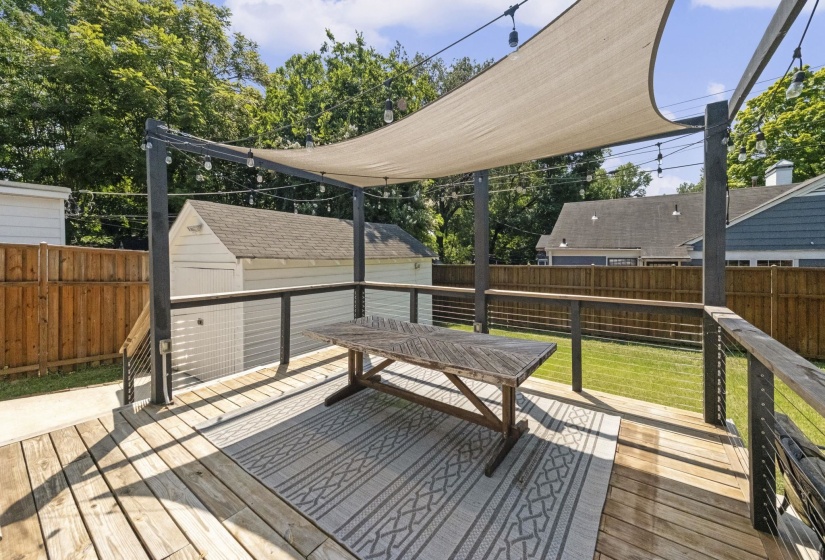 Expansive outdoor deck featuring wood flooring and cable railings