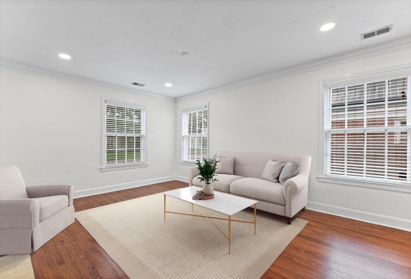 Bright interior space featuring recessed lighting, crown molding, wood-finish flooring, and white trim