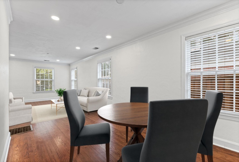 Open-concept living and dining area featuring rich wood-finish flooring