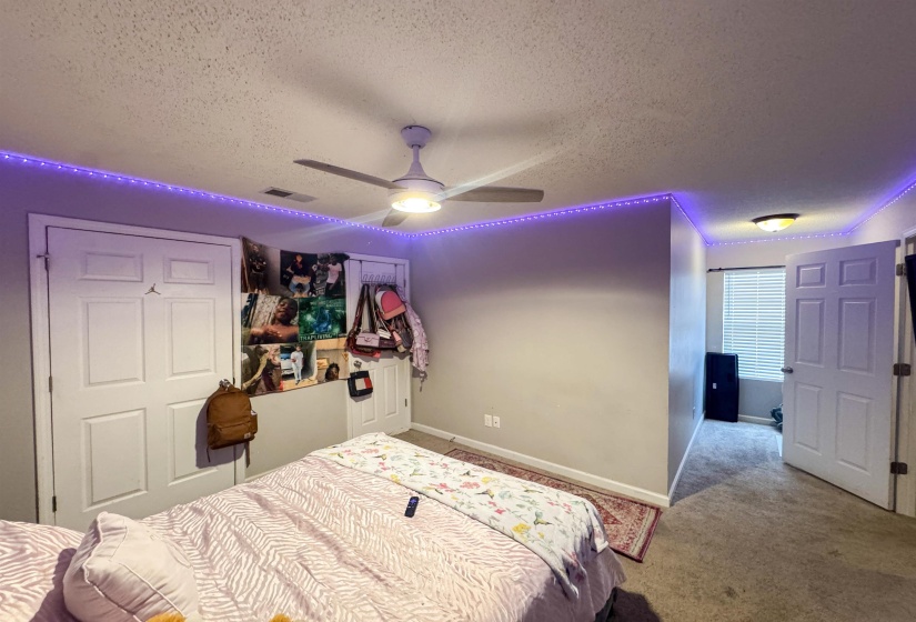 Interior room featuring a ceiling fan with integrated lighting