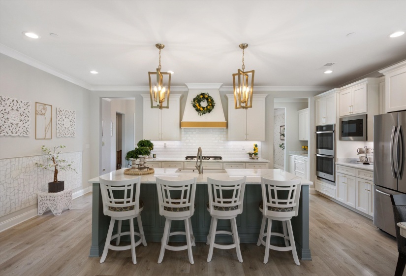 Central kitchen island with a stone countertop and seating for four