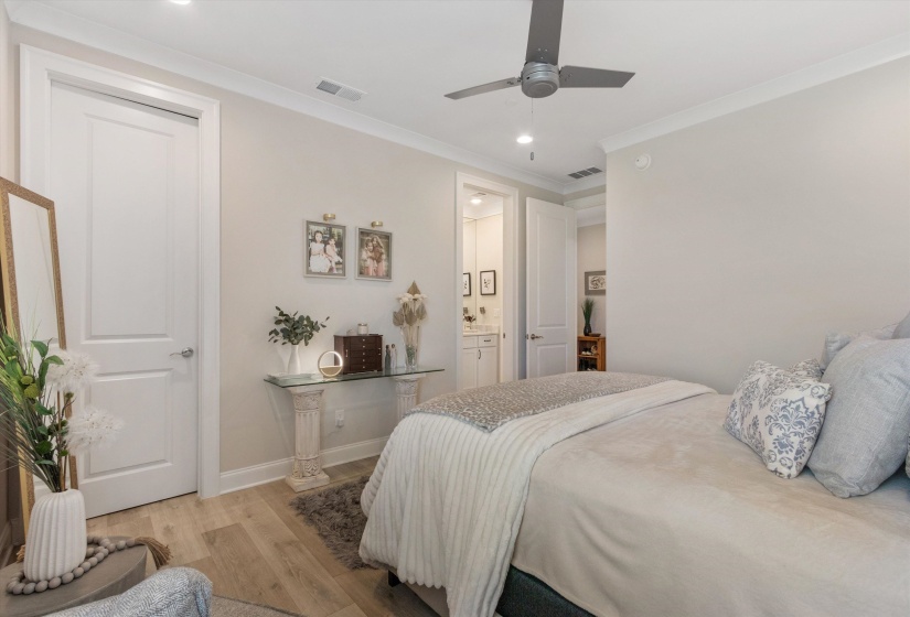 Light-toned walls with crown molding and wood-finish flooring