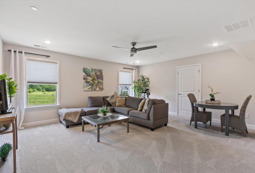 Carpeted bonus room featuring recessed lighting and a ceiling fan