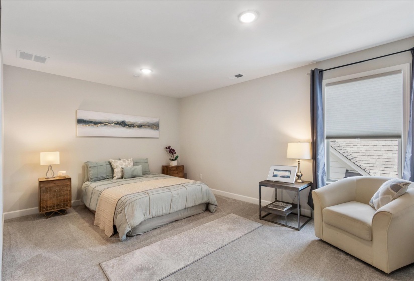 Carpeted room featuring recessed lighting, a window with blinds and dark curtains, and light neutral wall paint