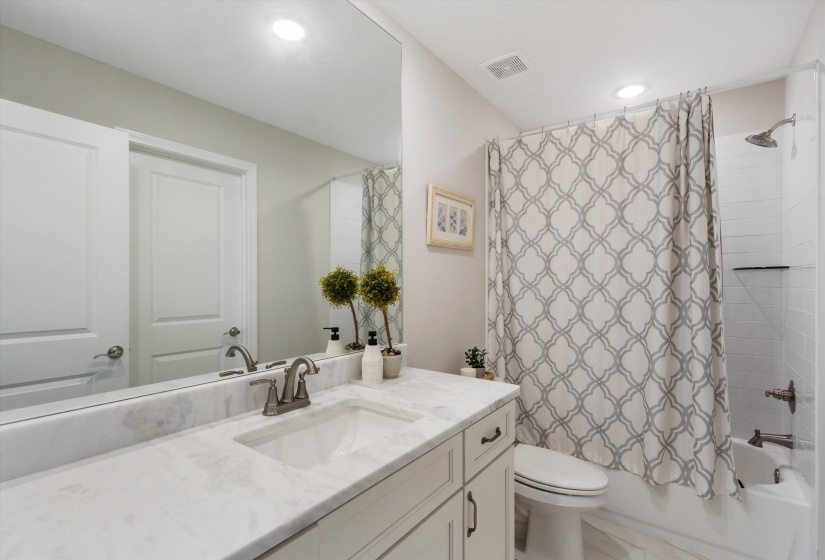 Bathroom featuring a white vanity with a stone countertop, an undermount sink, and a brushed nickel faucet