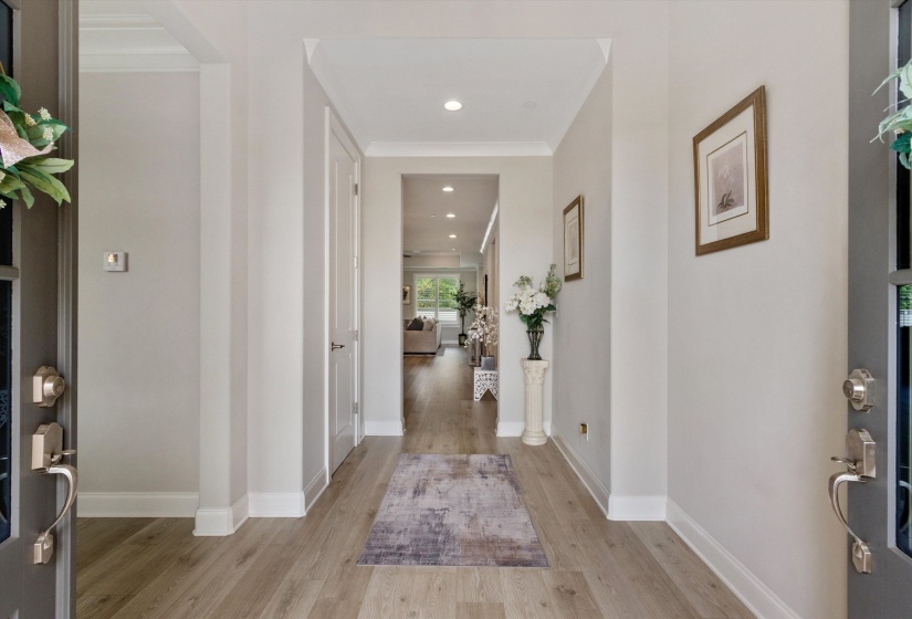Entryway featuring wood-finish flooring, recessed lighting, and crisp white baseboards