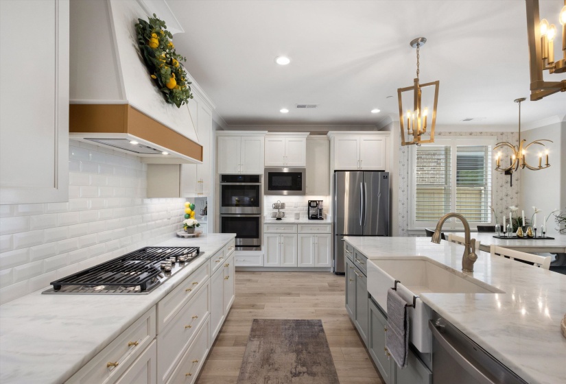 Gourmet kitchen featuring a gas cooktop, double wall ovens, built-in microwave, and stainless steel refrigerator